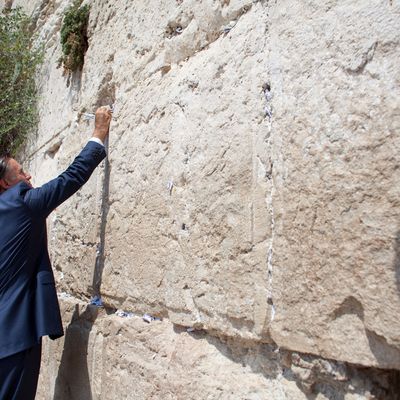 US Republican presidential candidate Mitt Romney places a hand-written prayer on the Western Wall on July 29, 2012 in Jerusalem's old city, Israel. Mitt Romney visits Israel as part of a three-nation foreign tour which also includes visits to Poland and Great Britain. 