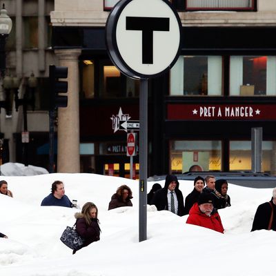 BOSTON - FEBRUARY 19: Pedestrians are obscured by snow banks in downtown Boston, Massachusetts February 19, 2015. (Photo by Jessica Rinaldi/The Boston Globe via Getty Images)