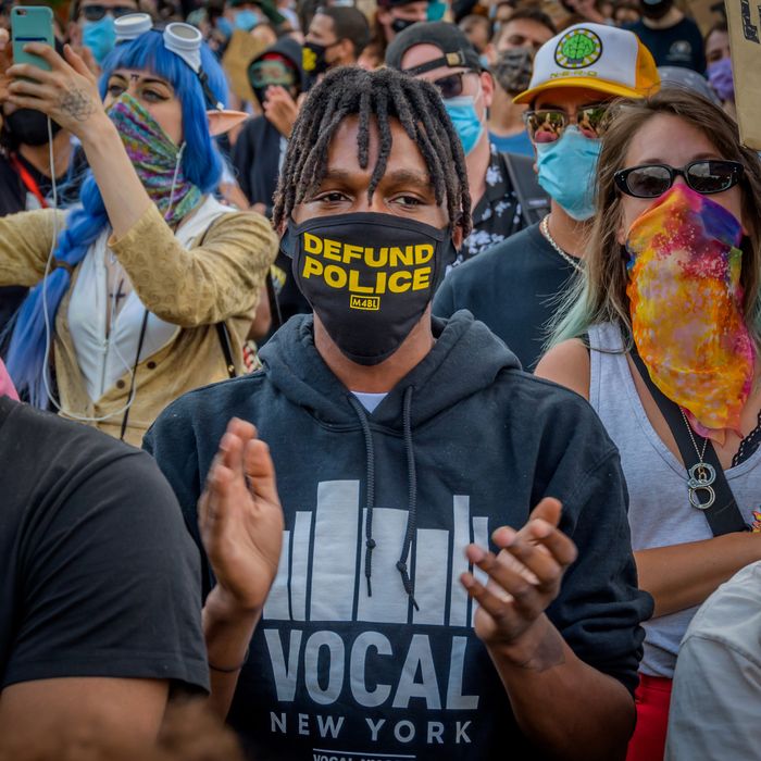 Protesters in New York wear 'Defund the Police' paraphernalia.