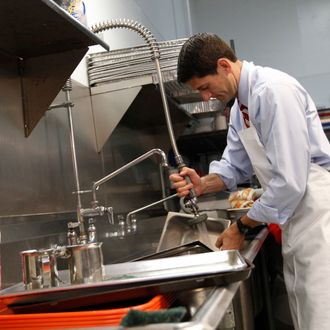Republican vice presidential candidate, Rep. Paul Ryan, R-Wis., and his wife Janna wash pots at St. Vincent DePaul dinning hall, Saturday, Oct. 13, 2012 in Youngstown, Ohio. (AP Photo/Mary Altaffer)