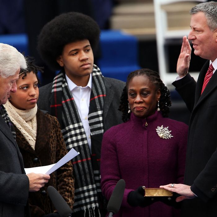 New York City's 109th Mayor, Bill de Blasio(right), is sworn in by former President Bill Clinton(left) as his family watches, Chiara de Blasio (2nd from left) Dante de Blasio (center) and wife Chirlane McCray (2nd from right) at City Hall on January 1, 2014 in New York City. Mayor de Blasio was sworn in using a Bible once owned by President Franklin Delano Roosevelt. Following the 12 years of the Michael Bloomberg administration, Mayor de Blasio won on a liberal platform that emphasized the growing gulf between the rich and poor in New York City. 