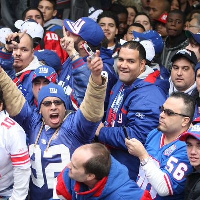 NEW YORK - FEBRUARY 05: New York Giants fans cheer the players as they pass in floats along Broadway, also known as 