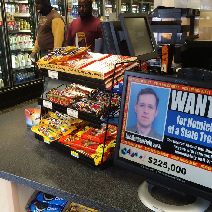 A video display at a convenience store shows a wanted poster of Eric Frein, a 31-year-old from Canadensis, Pa., Friday, Sept. 19, 2014, in Philadelphia. Frein is charged with killing Pennsylvania State Trooper Cpl. Bryon Dickson and wounding Trooper Alex Douglass in a late-night ambush Sept. 12 outside the Blooming Grove state police barracks. (AP Photo/Matt Slocum)