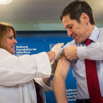 Dr. Thomas Frieden, Director of the Centers for Disease Control and Prevention, receives a flu shot from Sharon Bonadies at the conclusion of a press conference at the National Press Club in Washington, Thursday, Sept. 18, 2014. 