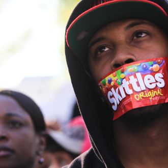College student Jajuan Kelley covers his mouth with a Skittles wrapper as he stands in a crowd of thousands rallying at the Georgia State Capitol in memory of slain Florida teenager Trayvon Martin on March 26, 2012 in Atlanta, Georgia. 
