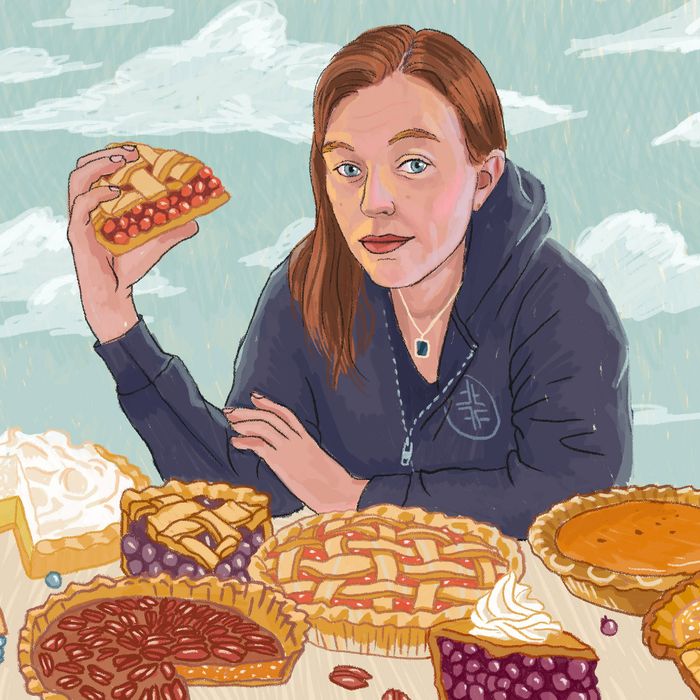 Illustration of Emily Flake in a blue hoodie surrounded by pies