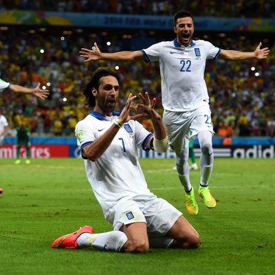 FORTALEZA, BRAZIL - JUNE 24: Giorgos Samaras (2nd R) of Greece celebrates scoring his team's second goal from the penalty spot with his teammates during the 2014 FIFA World Cup Brazil Group C match between Greece and Cote D'Ivoire at Estadio Castelao on June 24, 2014 in Fortaleza, Brazil. (Photo by Lars Baron - FIFA/FIFA via Getty Images)