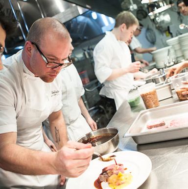 Chef Jared Van Camp sauces the ribeye before pickup.