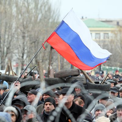 Pro-Russian supporters rally in front a barricade outside the regional state building in the eastern Ukrainian city of Donetsk on April 12, 2014. 