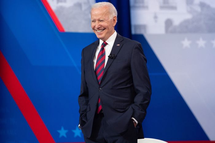 President Joe Biden smiling on a stage.