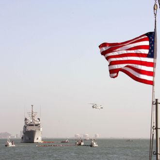 A US Navy Ocean Tug ship and a helicopter of the Bahrain-based Fifth Fleet particpate in a crisis response exercise in a port in the capital Manama, 06 November 2007.
