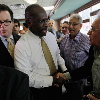 MIAMI, FL - NOVEMBER 16: Republican Presidential candidate Herman Cain greets people during a campaign visit to Versailles, a Cuban restaurant, in the Little Havana neighborhood on November 16, 2011 in Miami, Florida. Cain was in South Florida on a campaign swing. (Photo by Joe Raedle/Getty Images)