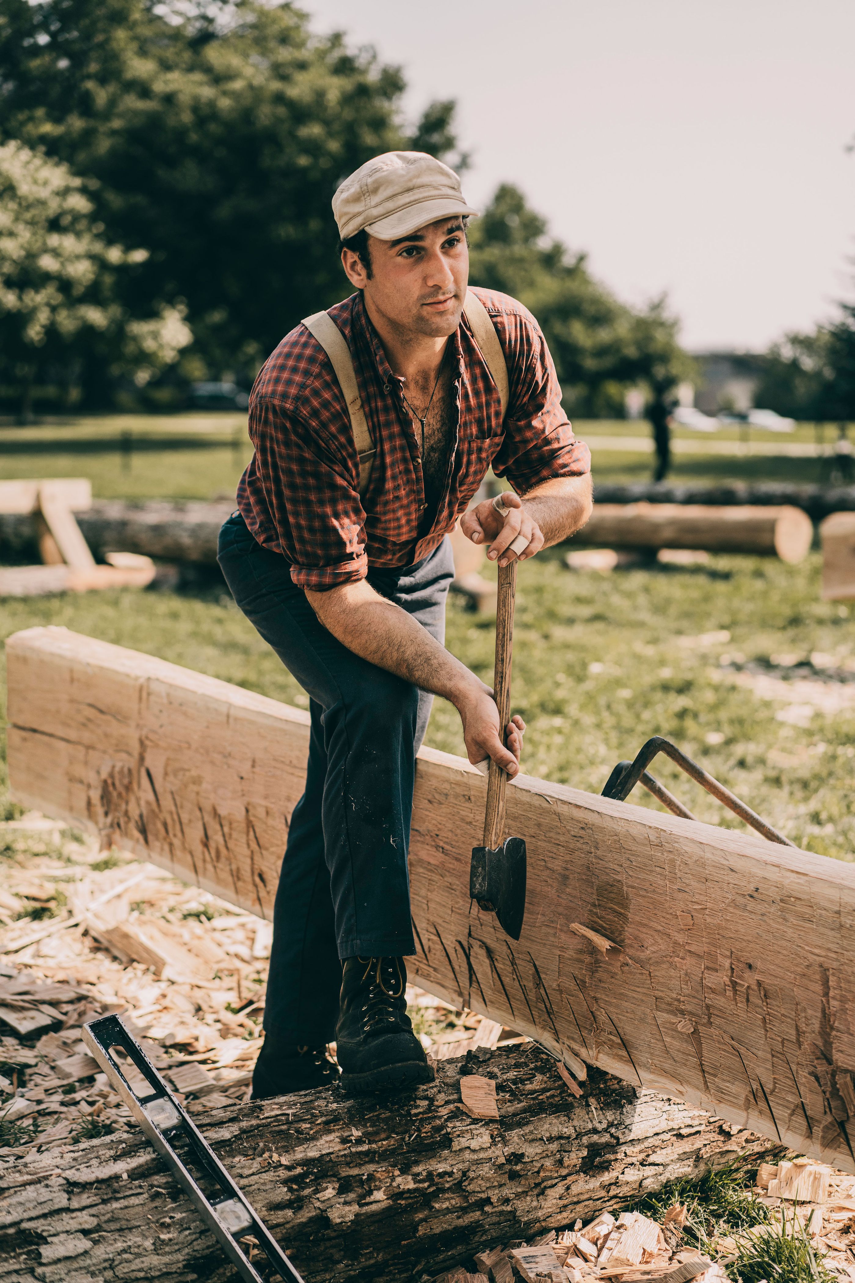 <p>Ethan Higgins scores a log, then “scrubs” with a broadaxe to shave off thin pieces.</p>