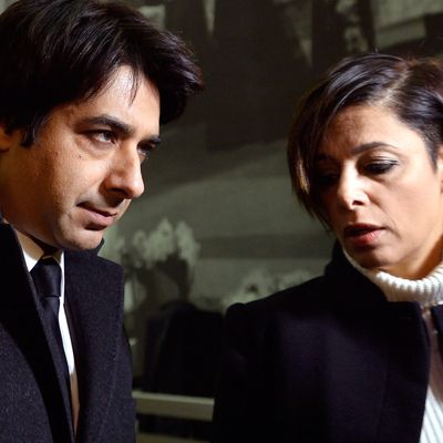 Jian Ghomeshi with his lawyer, as protesters picketed the courthouse.