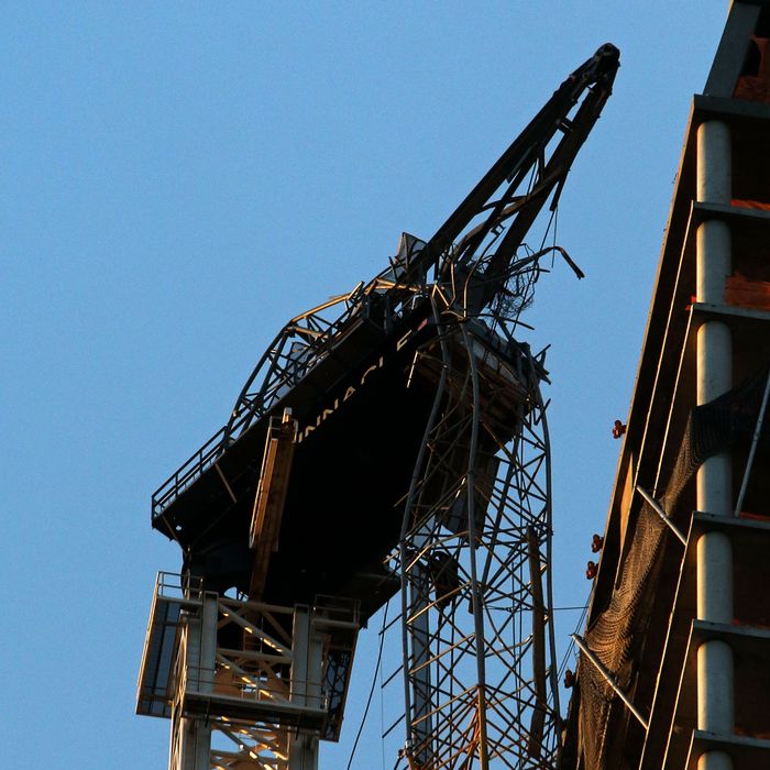 NEW YORK, NY - NOVEMBER 03: A construction crane hangs off of the side of One57 November 3, 2012 in New York City. Earlier in the day, construction workers secured the crane to the side of the building. The crane was blown loose from the residential construction project during Hurricane Sandy. US President Barack Obama has declared the situation a 'major disaster' for large areas of the US East Coast including New York City. (Photo by Michael Heiman/Getty Images)