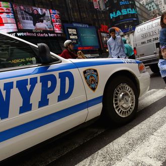 NEW YORK - MAY 26: Pedestrians in Times Square walk past a police car May 26, 2004 in New York City. The U.S. fears that al Qaeda may be plotting an attack inside the country or against U.S. interests abroad. Despite these warnings, the government has no plans to raise the terror threat level and has no details on when, where or how an attack might occur. (Photo by Spencer Platt/Getty Images)