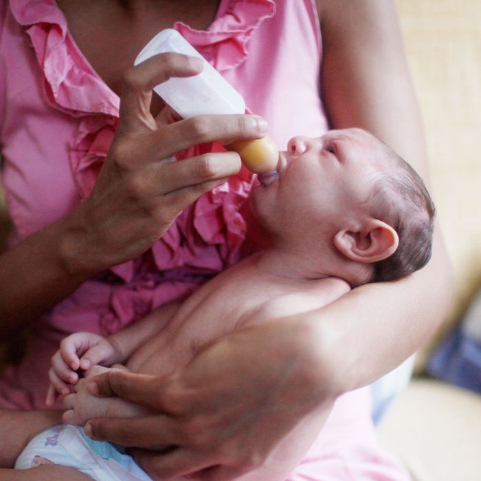 A woman in Recife, Brazil, feeds her son, who was born with microcephaly.
