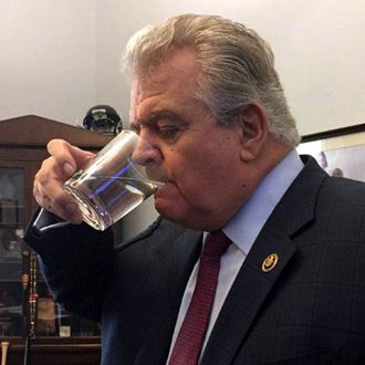 U.S. Rep. Bob Brady sips from the glass used by the pope.