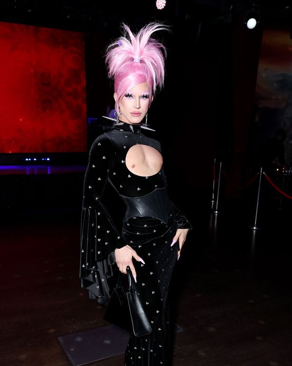 Aquaria poses at an after party with pink hair