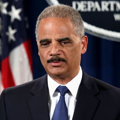 U.S. Attorney General Eric Holder (C) speaks as Deputy Attorney General James Cole (R) and IRS Commissioner John Koskinen (L) listen during a news conference at the Justice Department May 19, 2014 in Washington, DC. Swiss financial services holding company Credit Suisse AG has pleaded guilty to conspiracy to aid and assist U.S. taxpayers in filing false income tax returns and other documents with the IRS and has agreed to pay $2.6 billion in fine. 