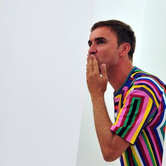 Belgian designer Raf Simons blows a kiss to the audience as he cries at the end of the Jil Sander Fall-winter 2012-2013 collection on February 25, 2012 during the Women's fashion week in Milan. The company announced the day before German fashion designer Jil Sander is set to make a return to the company that bears her name nearly eight years after resigning, with Simons leaving his position of creative director on February 27. AFP PHOTO / GIUSEPPE CACACE (Photo credit should read GIUSEPPE CACACE/AFP/Getty Images)