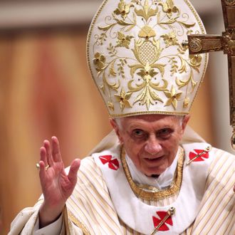 Pope Benedict XVI waves to the faithfuls as he leaves St. Peter's Basilica at the end of the Christmas night mass on December 24, 2012 in Vatican City, Vatican. 