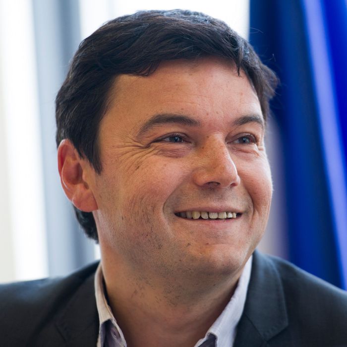 French economist Thomas Piketty smiles during a meeting at the National Assembly on March 13, 2013 in Paris. 