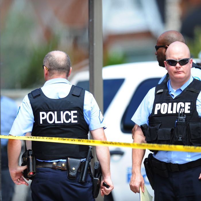 Police officers are seen at a crime scene involving a shooting of a man by St. Louis Metropolitan Police on August 19, 2014. Police in the US city of St. Louis shot dead another suspect on Tuesday, a short distance from a suburb that is the scene of protests over the killing of an unarmed black teenager. St. Louis Police Chief Sam Dotson said in a tweet that officers had responded to a call and found an apparently agitated man, armed with a knife who yelled 