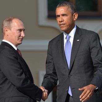  In this handout image provided by Host Photo Agency, Russian President Vladimir Putin (L) greets US President Barack Obama during an official welcome of G20 heads of state and government, heads of invited states and international organizations at the G20 summit on September 5, 2013 in St. Petersburg, Russia. The G20 summit is expected to be dominated by the issue of military action in Syria while issues surrounding the global economy, including tax avoidance by multinationals, will also be discussed during the two-day summit. 