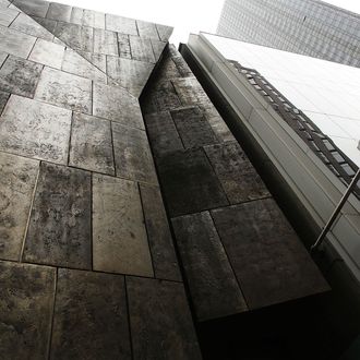 The former Museum of American Folk Art (L) stands next to the Museum of Modern Art (MoMA) on April 11, 2013 in New York City. MoMA announced yesterday that it will demolish the former Museum of American Folk Art, a building it purchased in 2011. The building, with a bronze sculptural facade, was architectonically acclaimed. MoMA says it needs to demolish the building in order to enlarge its own facilities.