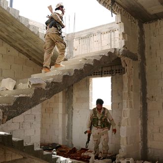 Fighters from Syria's Manbij military council are seen on June 15, 2016 in a building on the outskirts of the northern Syrian town of Manbij, which is held by jihadists of the Islamic State (IS) group, during an operation to try to retake the town.