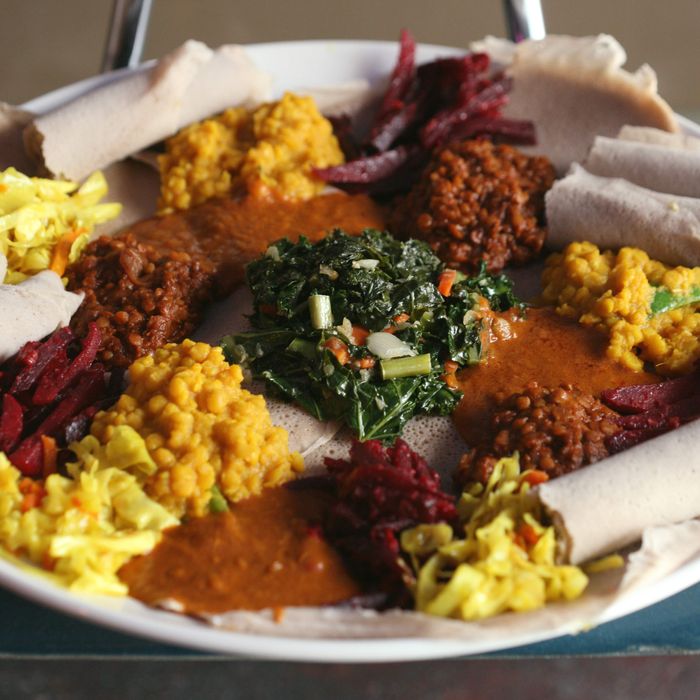A plate of kale, peas, potatoes, ground chickpeas, red lentils, and beets.