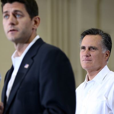 Republican presidential candidate and former Massachusetts Gov. Mitt Romney (R) looks on as Rep. Paul Ryan (R-WI) (L) speaks during a campaign rally at Randolph Macon College on August 11, 2012 in Ashland, Virginia. Mitt Romney kicked off a four day bus tour with an announcement of his running mate, Rep. Paul Ryan (R-WI). 