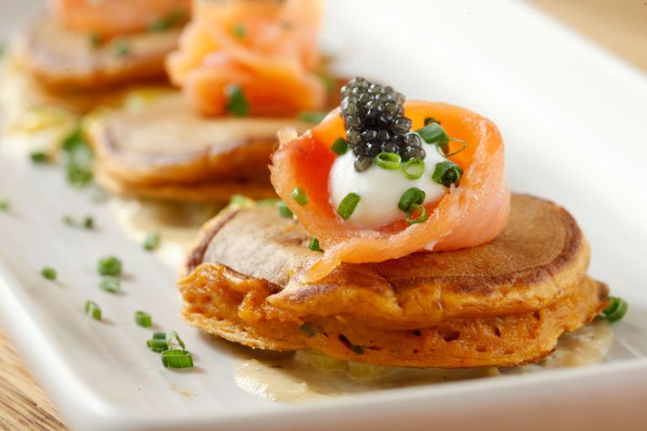 Jams pancakes with red pepper, smoked salmon, corn sauce, crème fraiche, and caviar.