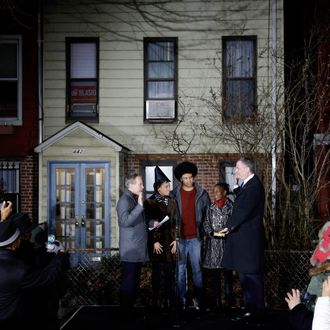 Bill de Blasio (R) is sworn in as mayor of New York City by State Attorney General Eric Schneiderman (L) while his family (L-R) Chiara de Blasio, Dante de Blasio and Chirlane McCray look on after midnight January 1, 2014 in the Park Slope neighborhood of the Brooklyn borough of New York City. De Blasio took the oath outside his home in Park Slope. His inauguration will be celebrated at noon today on the steps of City Hall when he takes the oath again, which will be administered by former U.S. President Bill Clinton. (Photo by Seth Wenig-Pool/Getty Images)