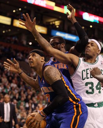 Carmelo Anthony #7 of the New York Knicks heads for the net as teammate Amare Stoudemire #1 blocks Paul Pierce #34 of the Boston Celtics