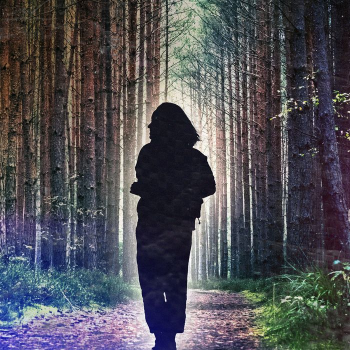 Portrait of a smiling woman in hiking attire looking away while