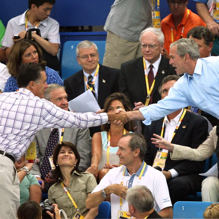 President of the United States, George W. Bush shakes hands with former Republican presidential hopeful and former Massachusetts Governor Mitt Romney at the swimming arena at the National Aquatics Center during day 2 of the Beijing 2008 Olympic Games on August 10, 2008 in Beijing, China.