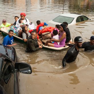 CORRECTS TO HOUSTON NOT THE WOODLANDS - Residents of the Arbor Court apartments evacuate their flooded apartment complex in the Greenspoint area on Monday, April 18, 2016, in Houston. (Brett Coomer/Houston Chronicle via AP) MANDATORY CREDIT