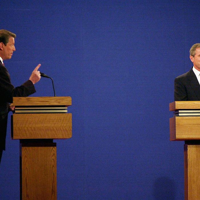 Republican presidential candidate George W. Bush (R) listens to his Democratic opponent Al Gore during their debate 03 October, 2000, at the University of Massachusetts-Boston. This is the first of three debates scheduled between the candidates, leading to the 07 November election.