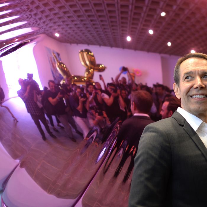 Artist Jeff Koons poses next to one of his sculptures during a press preview of 