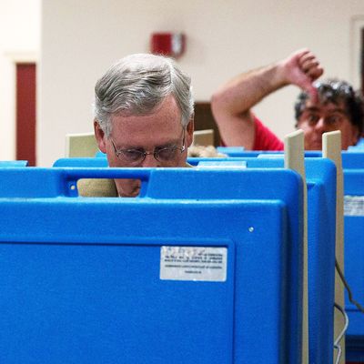  A voter gestures as Senate Minority Leader U.S. Sen. Mitch McConnell (R-KY) votes in the midterm elections at Bellarmine University November 4, 2014 in Louisville, Kentucky. McConnell is running in a tight race against opponent Kentucky Secretary of State Alison Lundergan Grimes. 