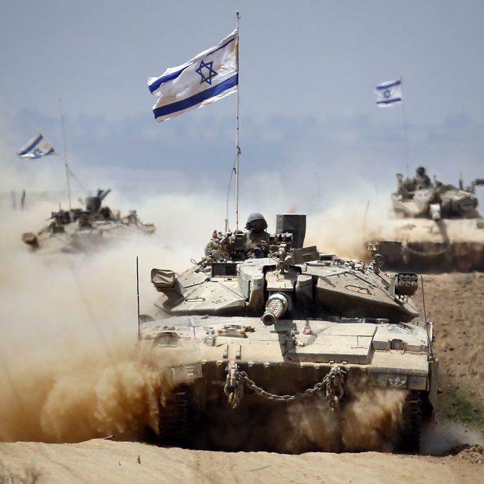 Israeli Merkava tanks roll near the border between Israel and the Gaza Strip as they return from the Hamas-controlled Palestinian coastal enclave on August 5, 2014, after Israel announced that all of its troops had withdrawn from Gaza. Israel completed the withdrawal of all troops from Gaza as a 72-hour humanitarian truce went into effect following intense global pressure to end the bloody conflict. AFP PHOTO / THOMAS COEX (Photo credit should read THOMAS COEX/AFP/Getty Images)