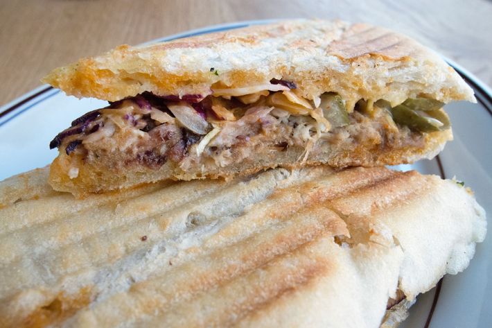 Porchetta panino with spicy pickle slaw.