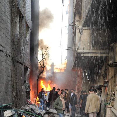 Syrian men inspect the scene of a car bomb explosion in Jaramana, a mainly Christian and Druze suburb of Damascus, on November 28, 2012. At least two car bombs exploded in Damascus killing and injureing a numbe of people.