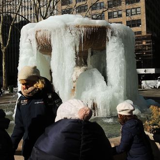 The frozen fountain at Bryant Park in Manhattan is viewed on a bitterly cold day on February 13, 2015 in New York City. In New York wind chill values of 5 to 10 degrees below zero were predicted with more cold weather in store for the weekend. 