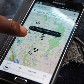  UberX driver checks the Uber customer app to see where other Uber drivers are working so he can determine where the best place for him to get fares might be, April 7, 2014, in Washington, DC. 