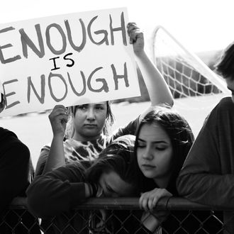 A student a Columbine High School holds up a sign that reads, 