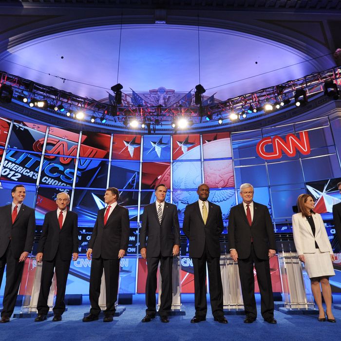 Republican presidential candidates arrive on stage prior to the start of the Republican presidential debate on national security November 22, 2011 at the Daughters of the American Revolution (DAR) Constitution Hall in Washington, DC. The debate is hosted by CNN in partnership with the Heritage Foundation and the American Enterprise Institute. From left are: Former Pennsylvania senator Rick Santorum; Texas Rep. Ron Paul; Texas Gov. Rick Perry; former Massachusetts governor Mitt Romney; businessman Herman Cain; for House speaker Newt Gingrich; Minnesota Rep. Michele Bachmann; and former Utah governor Jon Huntsman. AFP PHOTO / Mandel NGAN (Photo credit should read MANDEL NGAN/AFP/Getty Images)