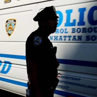 NEW YORK, NY - JULY 28: Police stand near where two U.S. Marshals and one New York Police Department (NYPD) detective were shot in the afternoon along a quiet street on July 28, 2014 in the West Village of Manhattan, New York City. While details are still emerging, the officer and marshals were trying to apprehend a suspect who was shot and killed in the incident. (Photo by Spencer Platt/Getty Images)